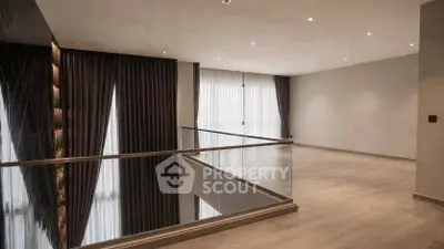 Spacious modern interior with elegant flooring and large windows, perfect for luxury living.