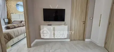 Modern interior with wall-mounted TV and stylish bedroom view