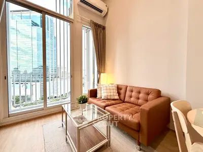 Modern living room with leather sofa and city view through large windows.