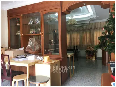 Spacious living room with elegant wooden cabinetry and festive decor