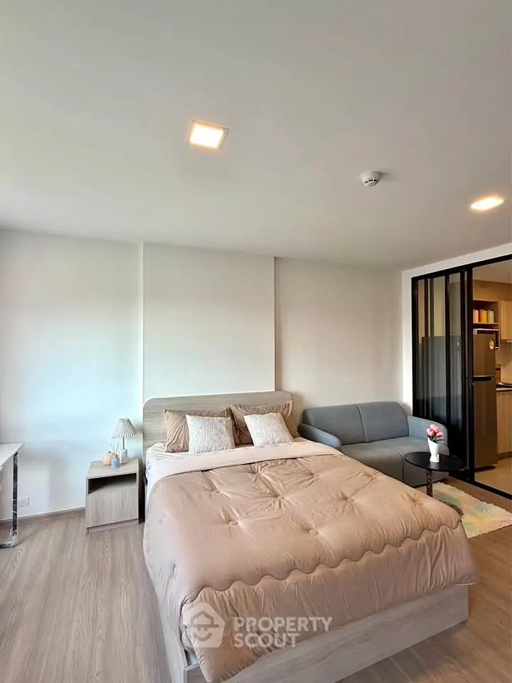 Modern bedroom with cozy bed and stylish decor in a contemporary apartment.