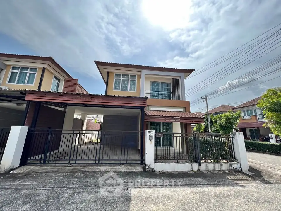 Modern two-story house with gated driveway and contemporary design