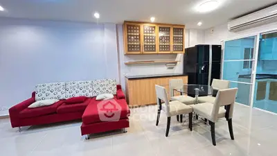 Modern living room with red sectional sofa and dining area in open layout