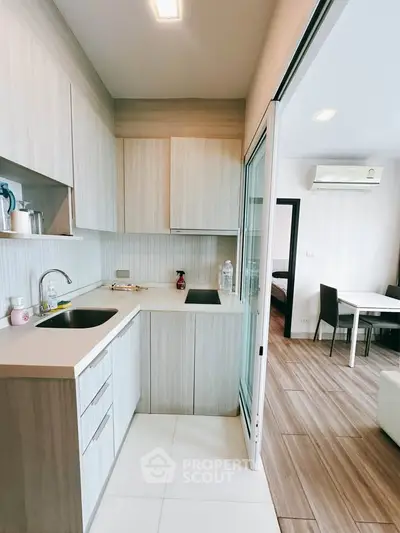 Modern kitchen with sleek cabinetry and open layout in stylish apartment