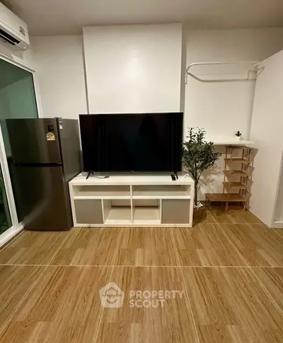 Modern living room with sleek TV setup and stylish wooden flooring