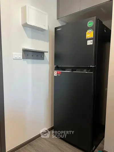 Modern kitchen with sleek black refrigerator and stylish cabinetry