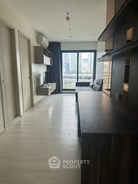 Modern living room with city view and sleek furniture, perfect for urban living.