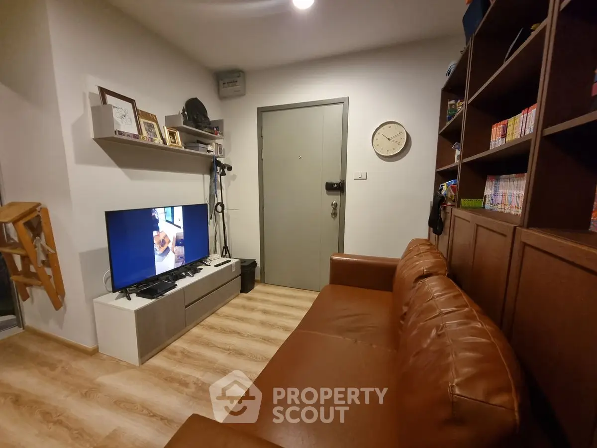 Cozy living room with leather sofa and modern TV setup
