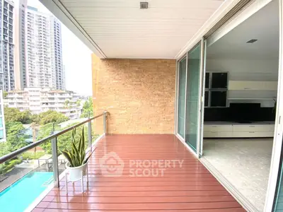 Spacious balcony with pool view and sliding glass doors in modern apartment