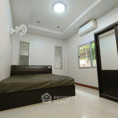 Spacious bedroom with modern ceiling fan and air conditioning