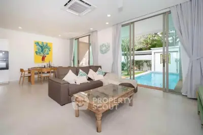 Spacious living room with pool view in modern home