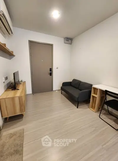 Modern minimalist living room with sleek furniture and wooden flooring, perfect for urban living.