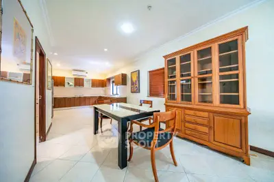 Spacious dining area with elegant wooden furniture and open kitchen layout