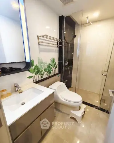 Modern bathroom with sleek fixtures and glass shower enclosure