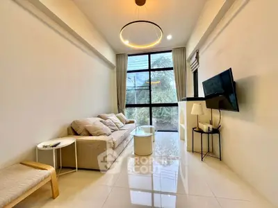 Modern living room with large window and stylish decor