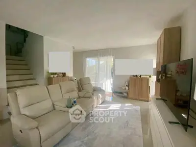 Spacious living room with modern furniture and natural light