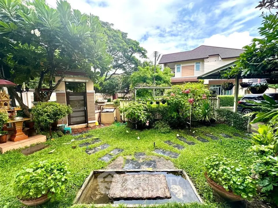 Charming garden view with lush greenery and serene outdoor space in a residential area.