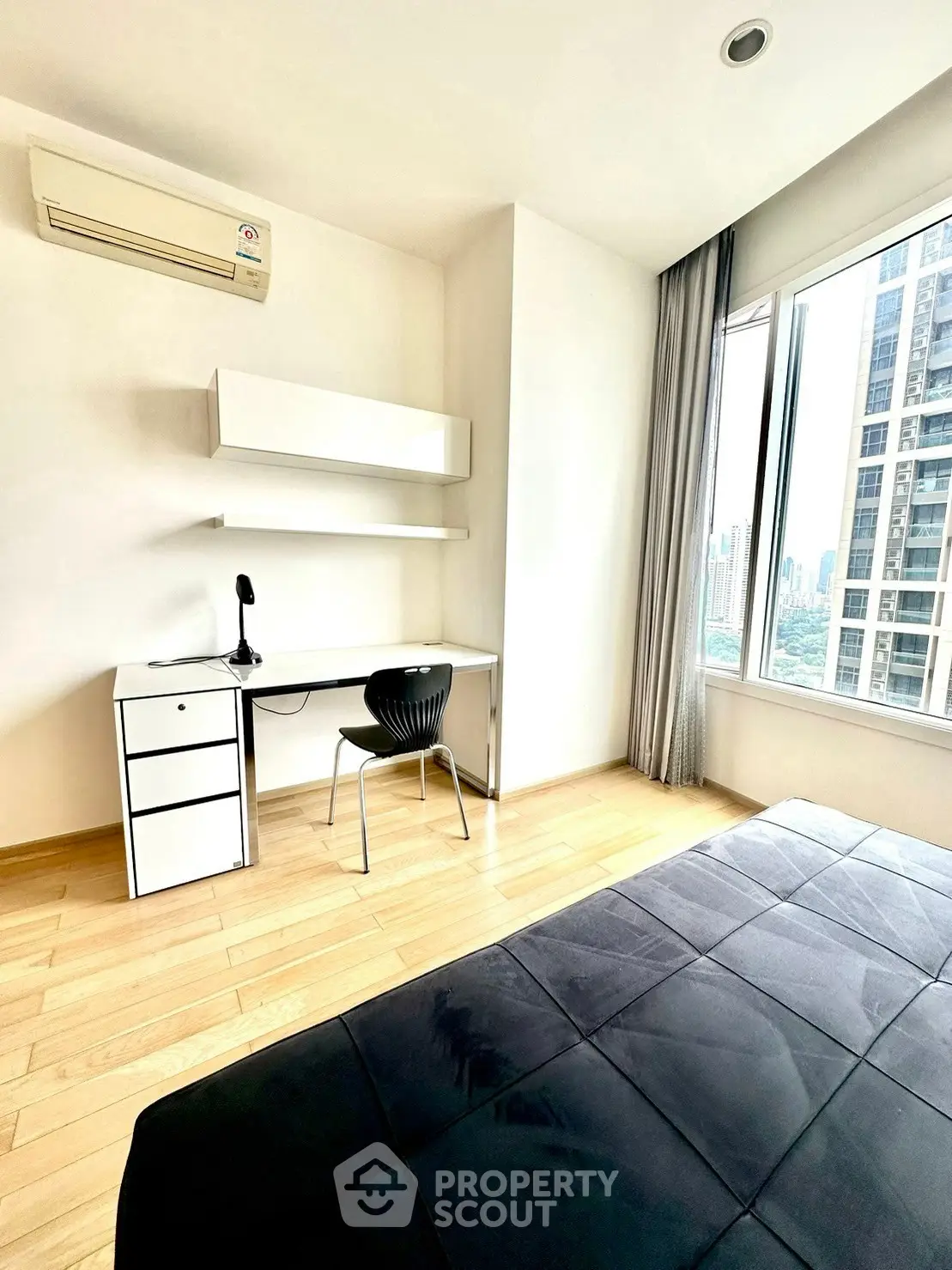 Modern bedroom with study area and city view