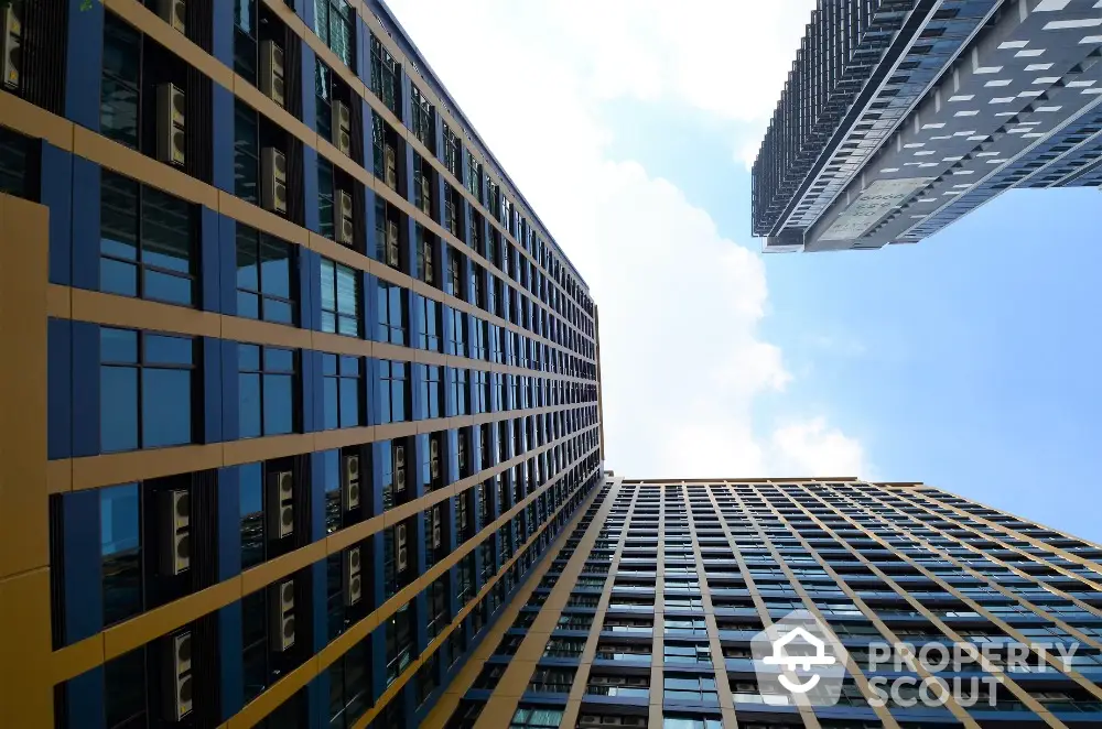 Stunning modern high-rise buildings with sleek glass facades against a clear blue sky.