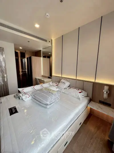 Luxurious modern bedroom with elegant lighting and stylish decor, perfect for relaxation and comfort.