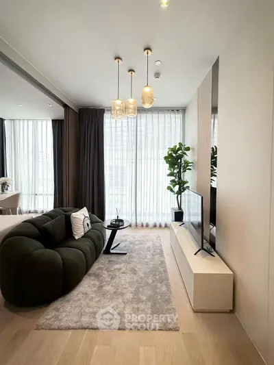 Modern living room with plush sofa, sleek TV unit, and floor-to-ceiling windows for natural light.