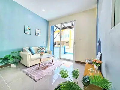 Bright and airy living room with modern decor and large glass doors leading to a sunny patio.