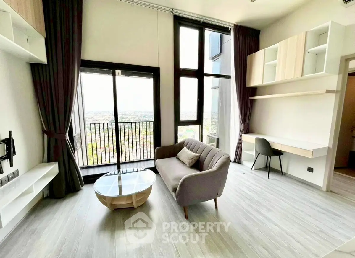 Modern living room with high ceilings, large windows, and stylish furniture in a contemporary apartment.