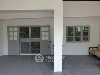 Spacious covered patio with modern windows and seating area.