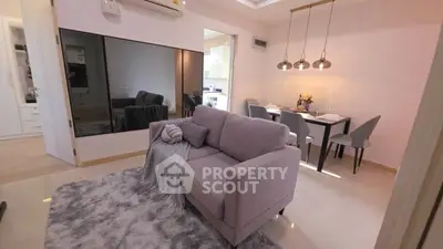 Modern living room with cozy sofa and dining area in open layout