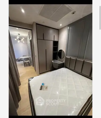 Modern bedroom with sleek design and built-in wardrobe in a stylish apartment.