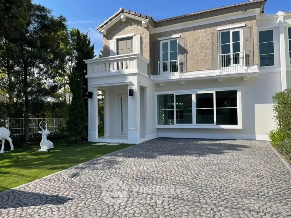 Elegant two-story house with stone facade and spacious driveway