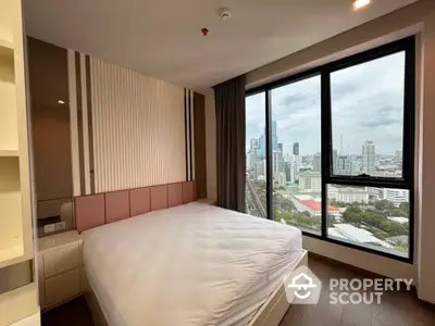 Modern bedroom with panoramic city view and large windows