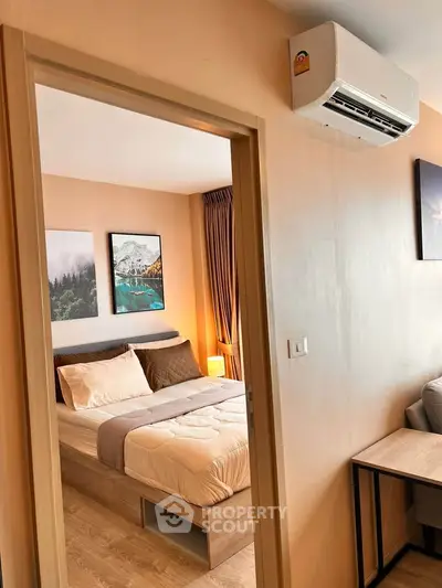 Cozy bedroom with modern decor and air conditioning in a stylish apartment.