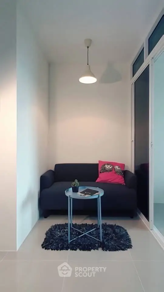 Cozy small living area with modern sofa and pendant light