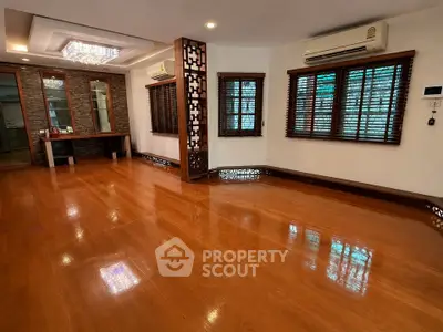 Spacious living room with wooden flooring and elegant decor