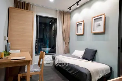 Modern bedroom with stylish decor and natural light, featuring a cozy bed and a functional workspace.