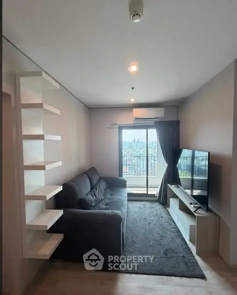 Modern living room with balcony view, featuring sleek furniture and natural light.
