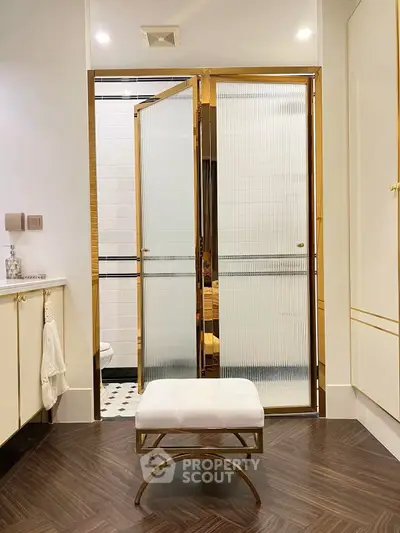 Luxurious bathroom with gold accents and elegant seating