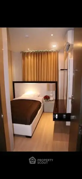 Cozy modern bedroom with elegant decor and warm lighting, perfect for relaxation and comfort.