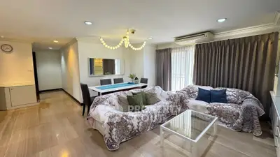 Spacious living room with elegant decor and ample natural light in a modern apartment.