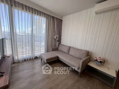 Modern living room with large window and city view, featuring a cozy sofa and air conditioning.