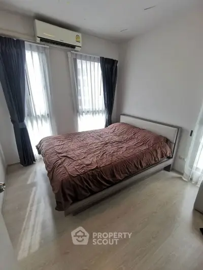 Cozy bedroom with natural light and modern decor in a stylish apartment.