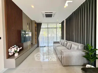 Modern living room with sleek design, large windows, and elegant decor for a luxurious lifestyle.