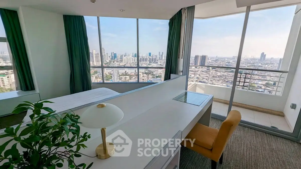 Spacious bedroom with stunning city view and private balcony in modern high-rise apartment.