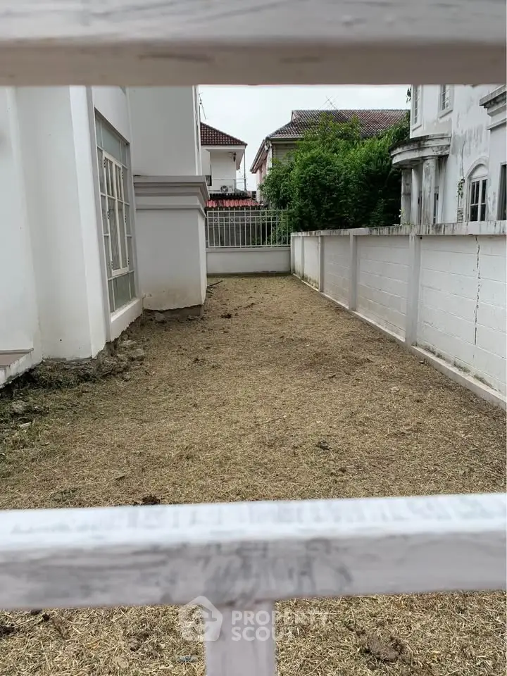 Spacious backyard area with potential for landscaping in suburban home.