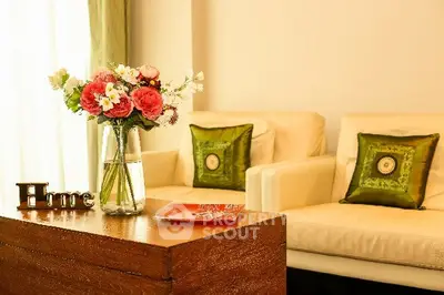Elegant living room with cozy seating and floral decor, perfect for relaxation and entertaining guests.