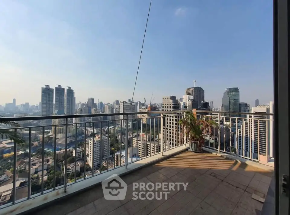 Stunning cityscape view from a spacious balcony in a high-rise apartment.
