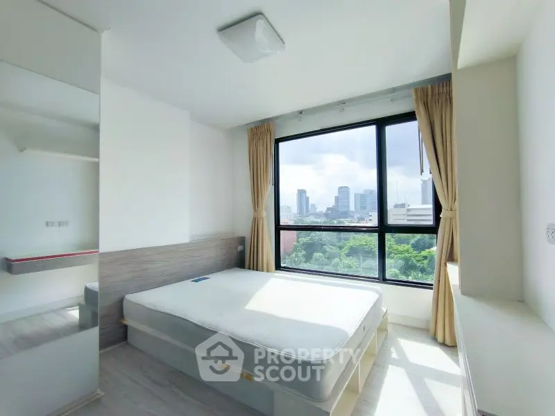 Bright bedroom with large window and city view, modern minimalist design.