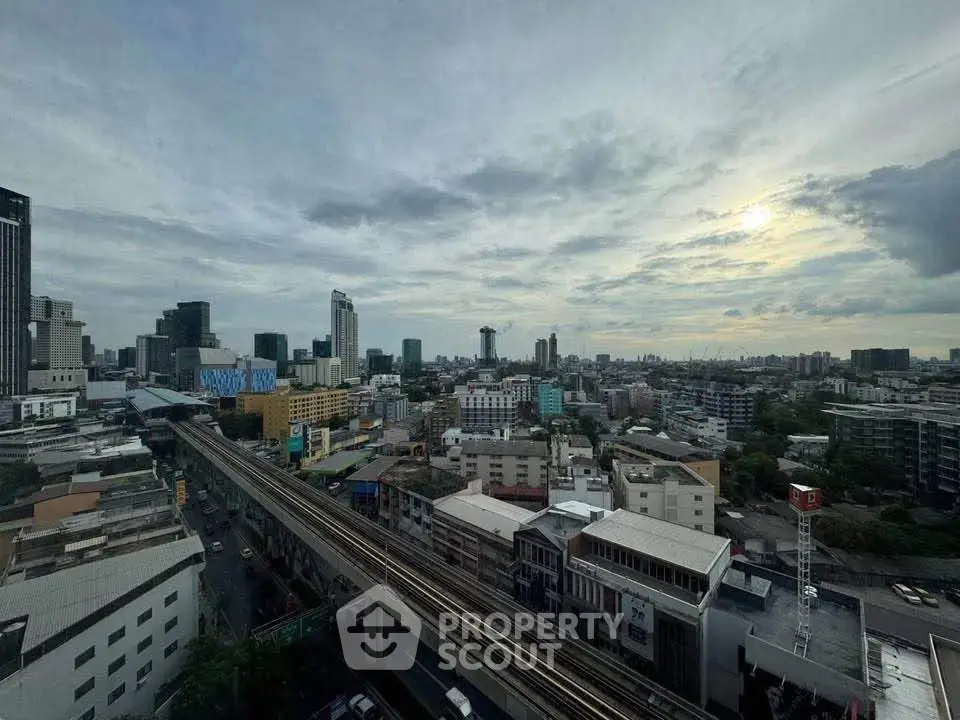 Stunning cityscape view from high-rise building showcasing urban skyline and transportation infrastructure.