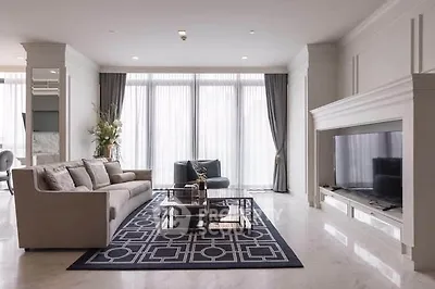 Luxurious living room with elegant decor and large windows offering natural light.